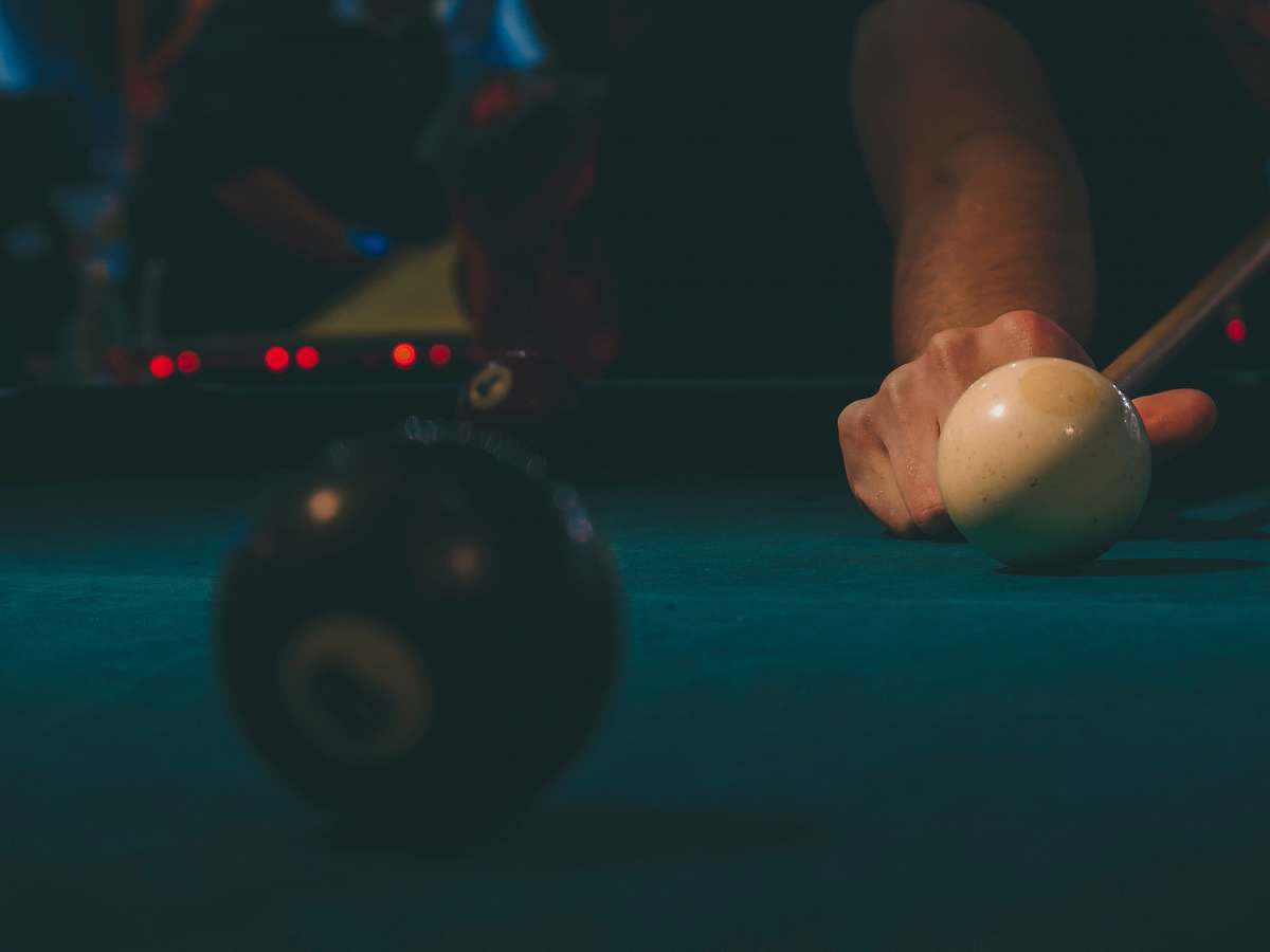sphere person playing billiards brown