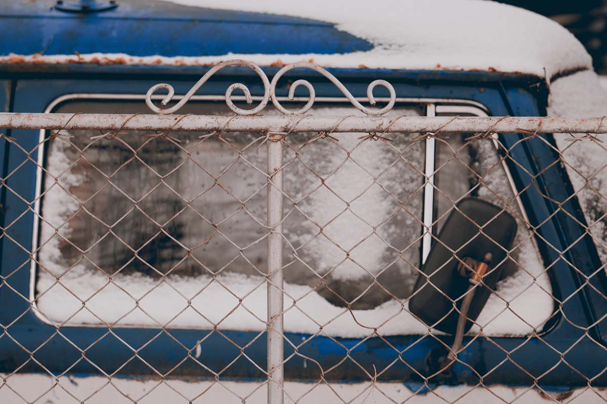 handrail blue and white van near white metal fence railing