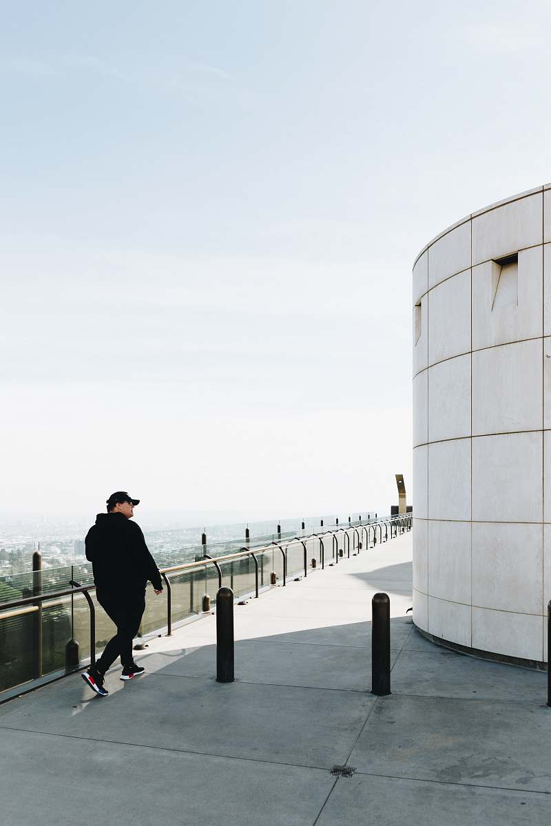 handrail man walking on focus photography railing