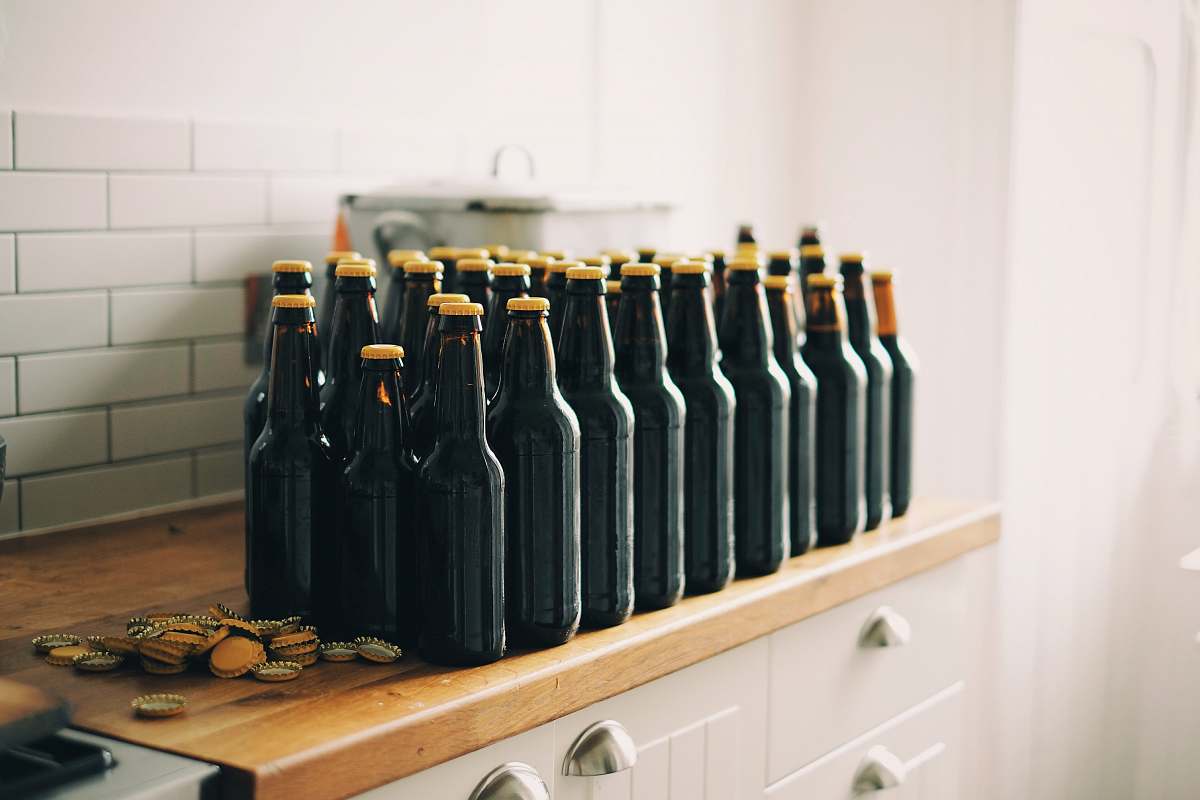 bottles black tinted glass bottle lot on brown and white wooden cabinet bottle