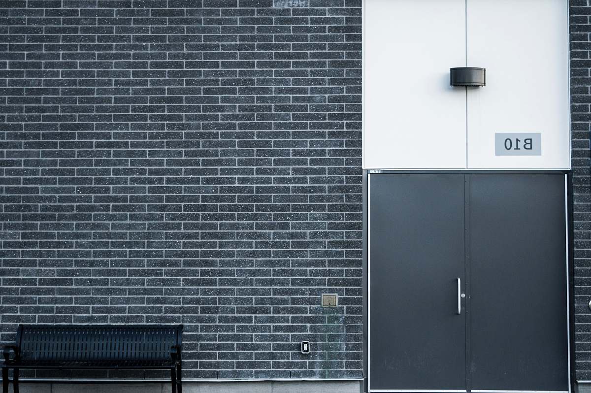 wall black metal bench brick