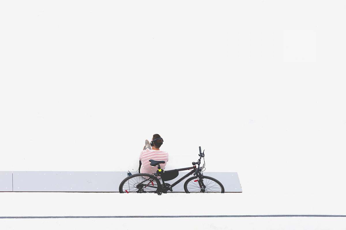 bike man sitting beside black mountain bike transportation
