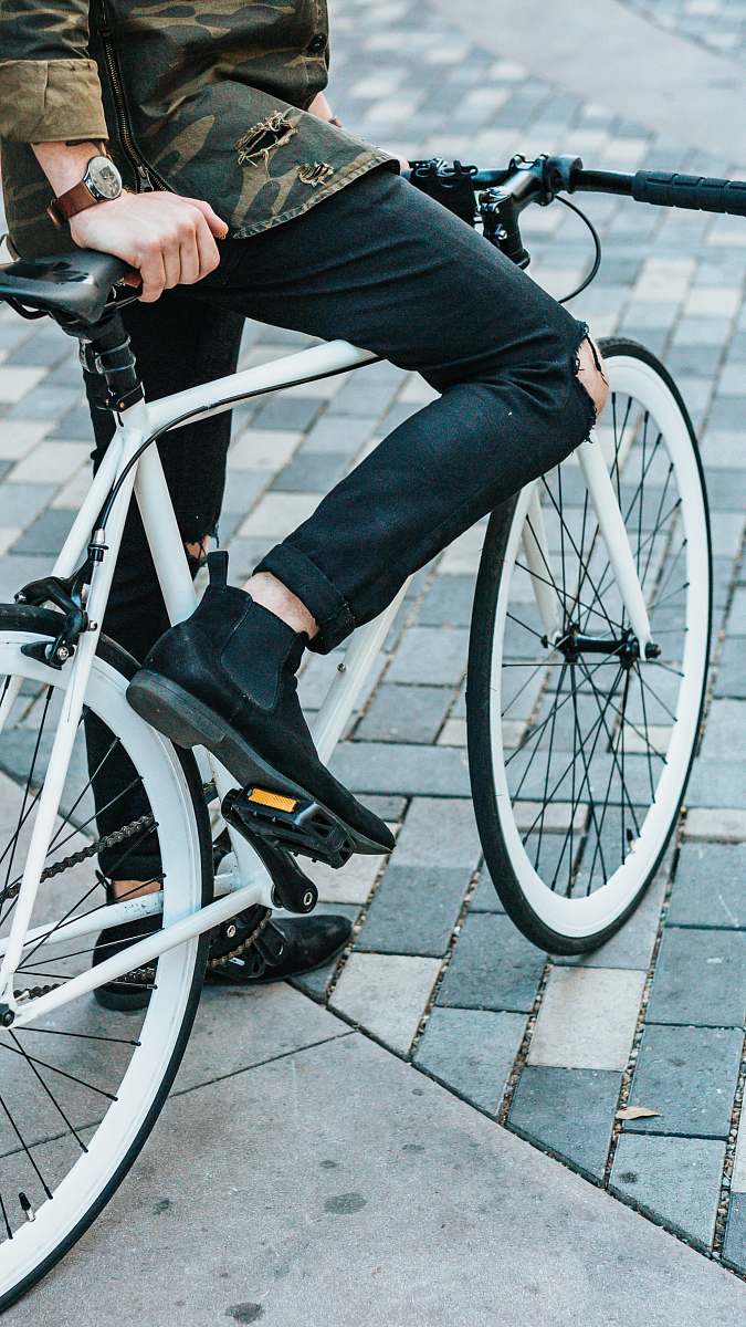 bike man wearing black pants riding white commuter bike fashion