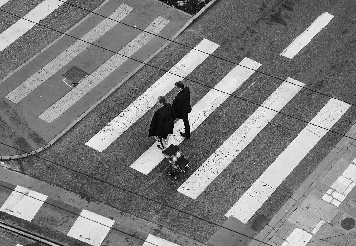 france aerial photography of men walking on pedestrian lane road