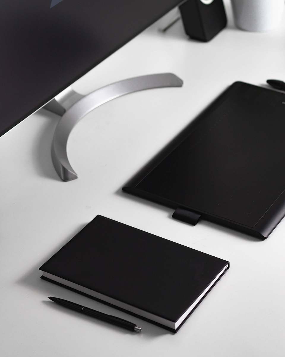 pc black click pen beside book and tablet computer cell phone