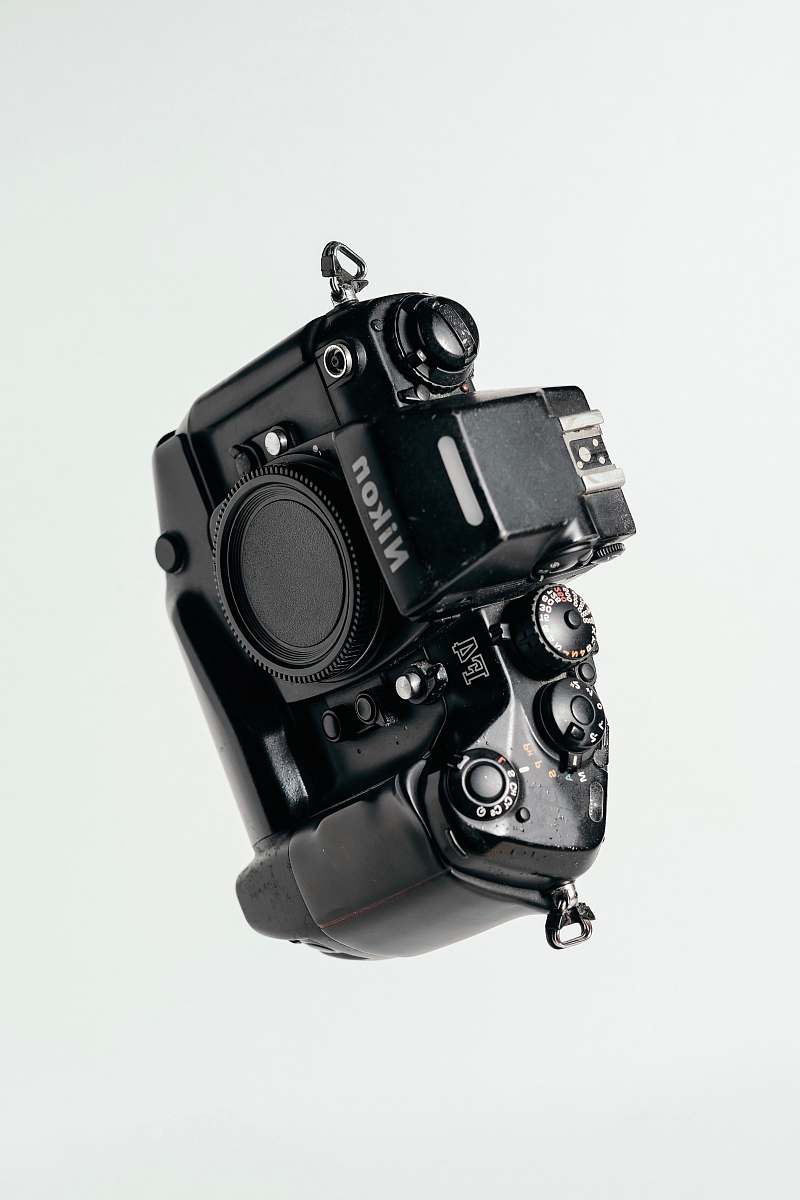 electronics black Nikon DSLR camera on whit surface camera