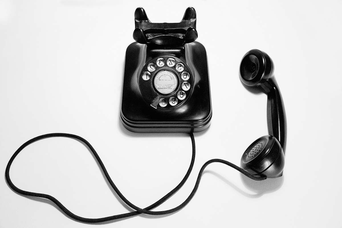 phone black rotary dial phone on white surface electronics
