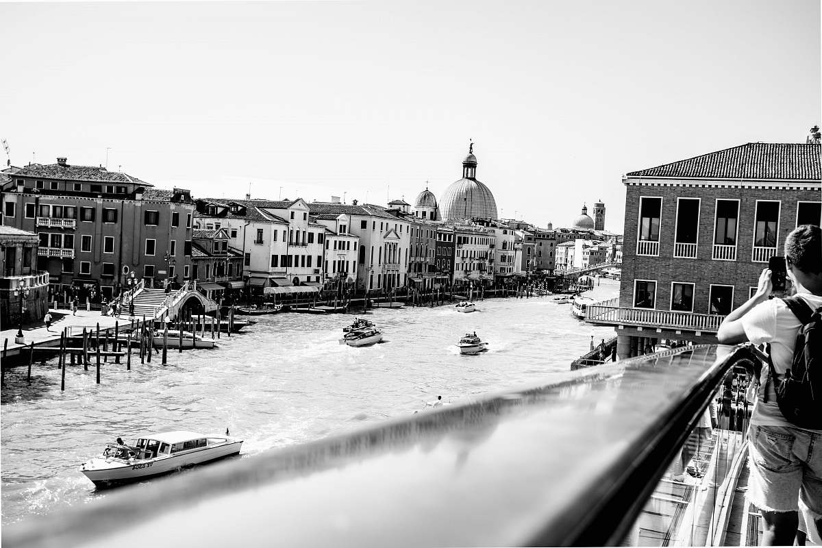A tranquil scene featuring a woman standing on a picturesque bridge, contemplating the vast ocean waters below. This captivating image captures the essence of solitude and reflection, making it perfect for use in travel blogs, wellness articles, and inspirational content. The peaceful atmosphere evokes a sense of connection with nature, ideal for projects focused on mindfulness, adventure, and the beauty of aquatic landscapes.