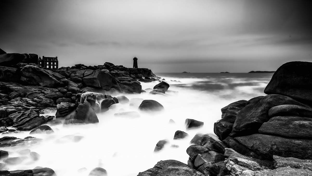 architecture body of water and rocks during day tower