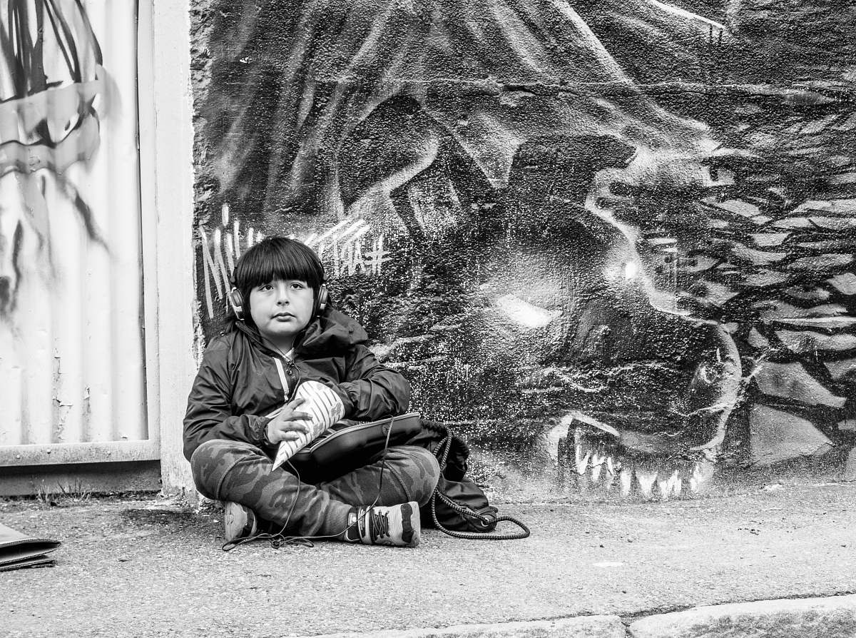 human boy sits on the street person