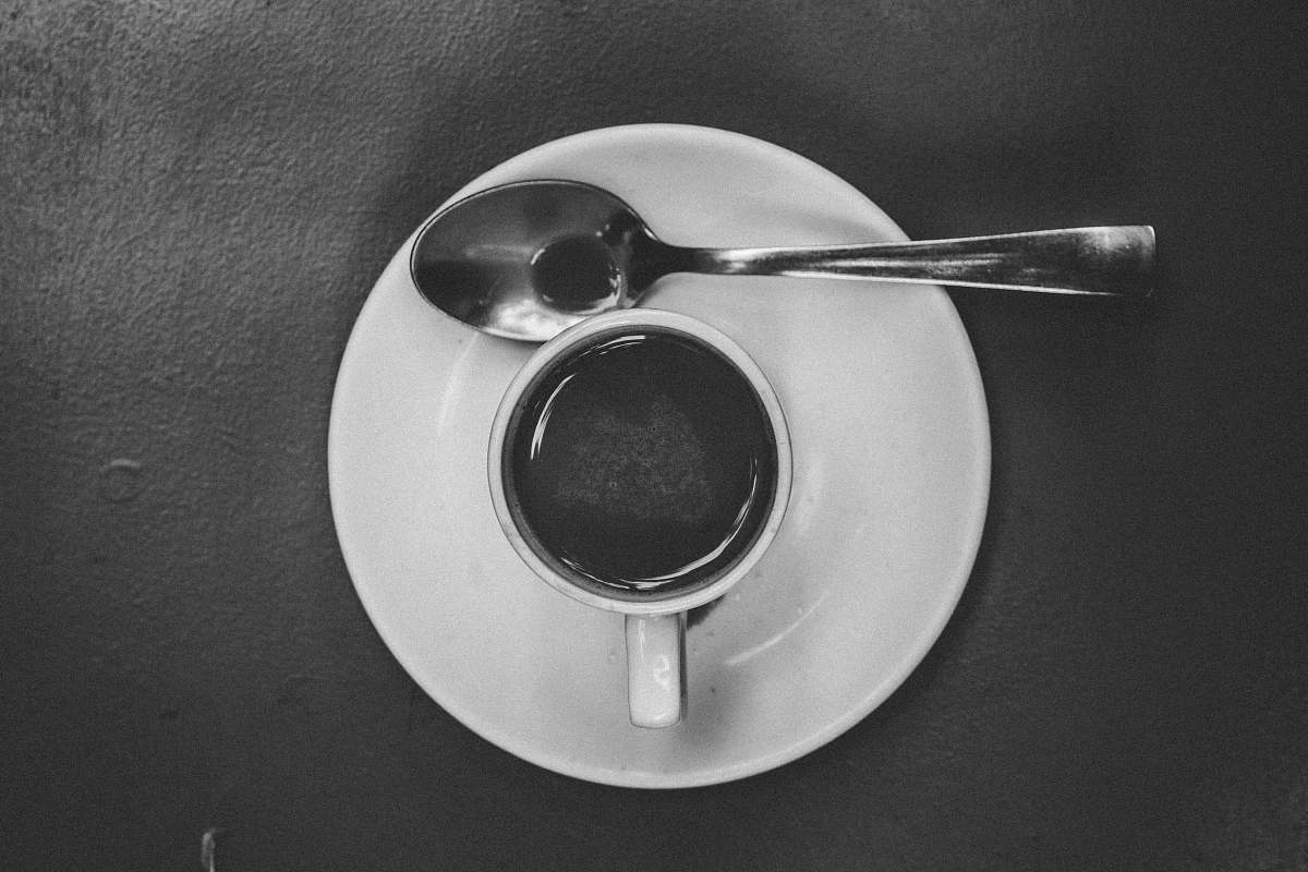 grey cup and saucer with spoon cafe des arts