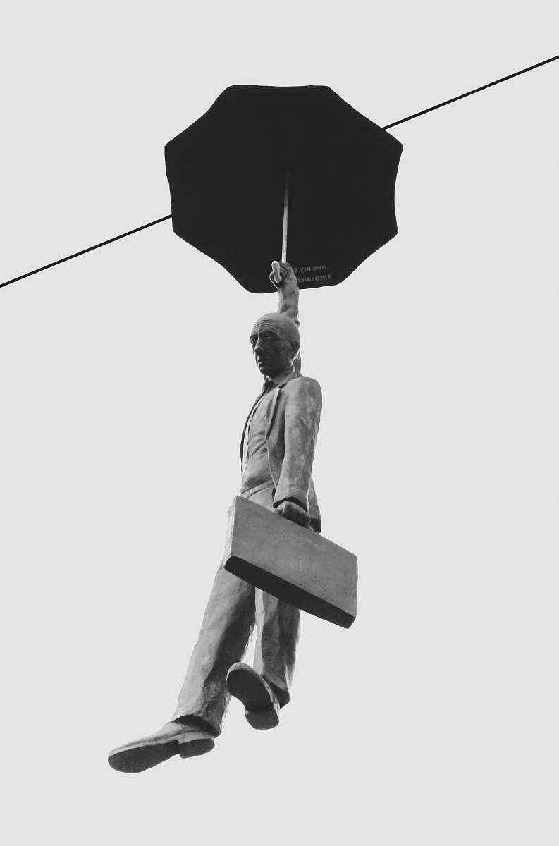 human floating man holding umbrella statue person