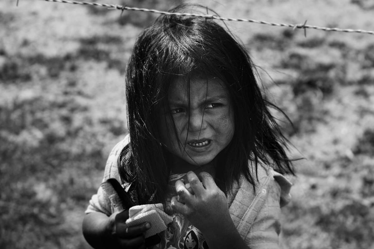 portrait girl holding hair comb behind barbed wire human
