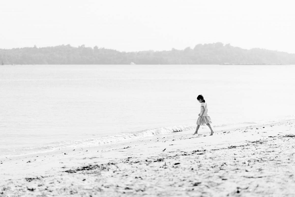 sand girl walking on beach during day time alone