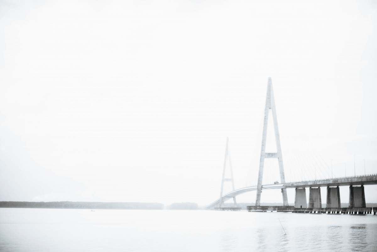 white gray concrete bridge under cloudy sky building
