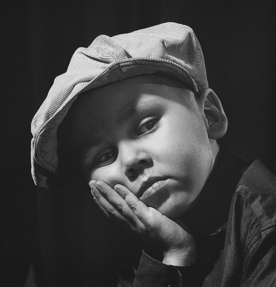 grey gray-scale photo of boy wearing cap apparel