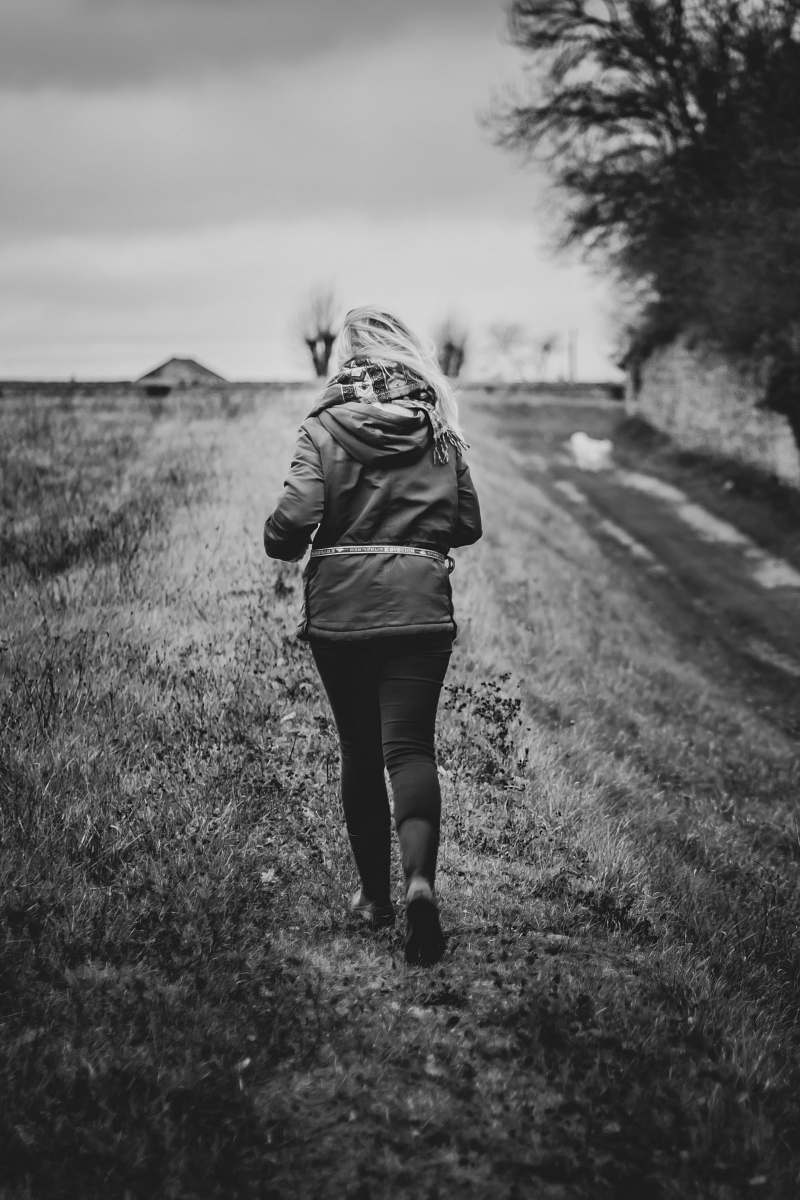 apparel gray scale photography of woman about to run wearing hoodie clothing