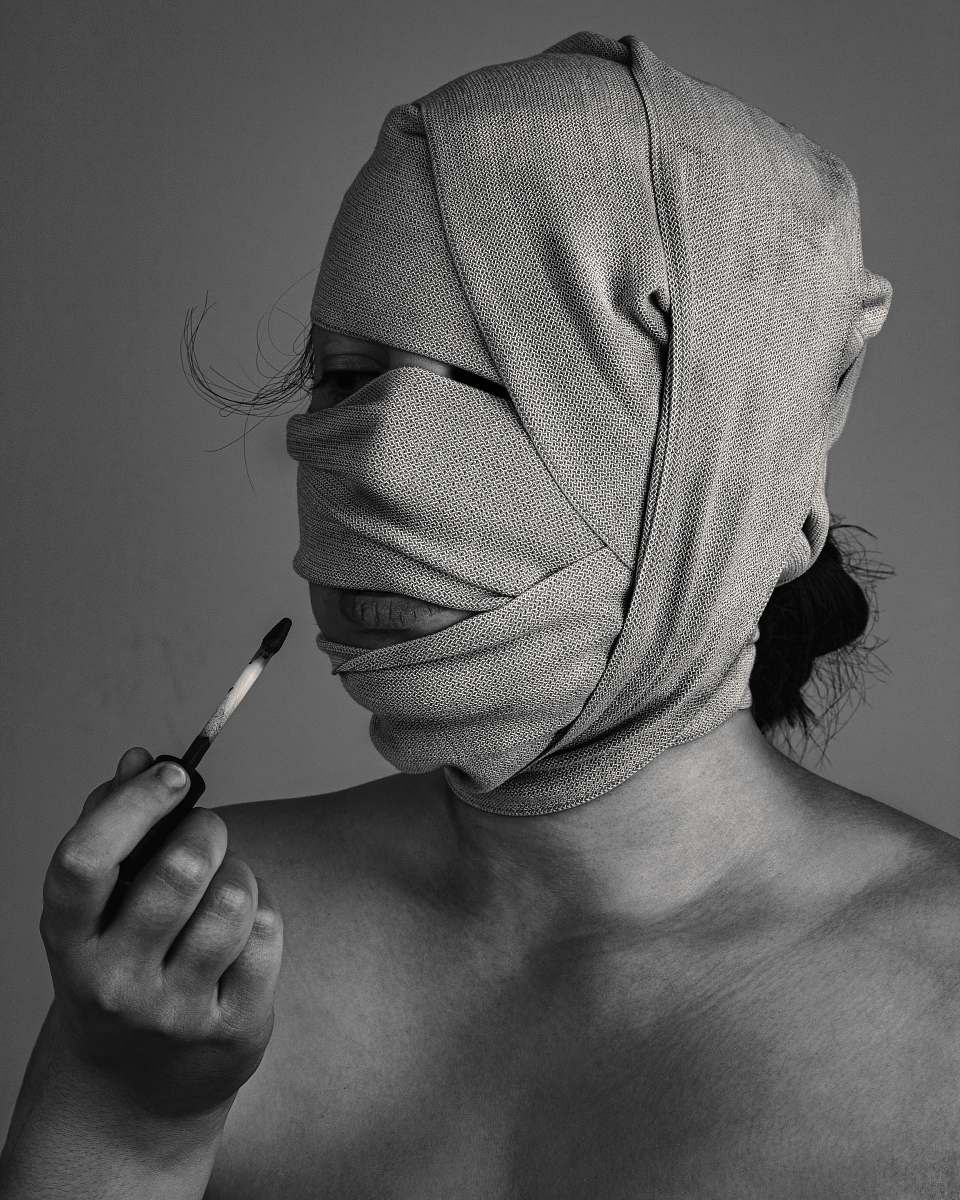 grey grayscal photo of woman with bandage on face skin