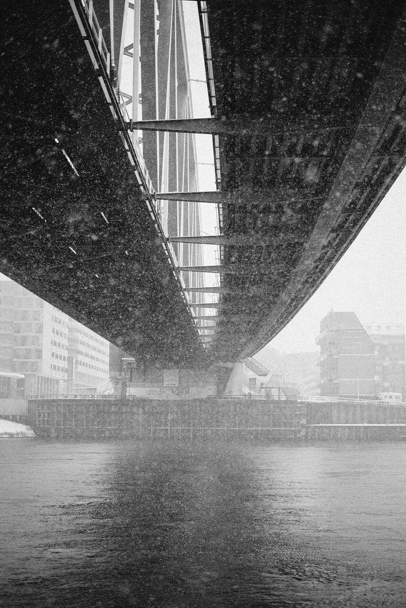 bridge grayscale architectural photography of metal bridge underneath nijmegen