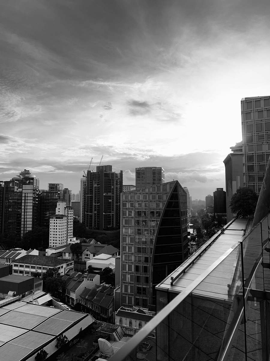 building grayscale photo buildings under cloudy sky office building