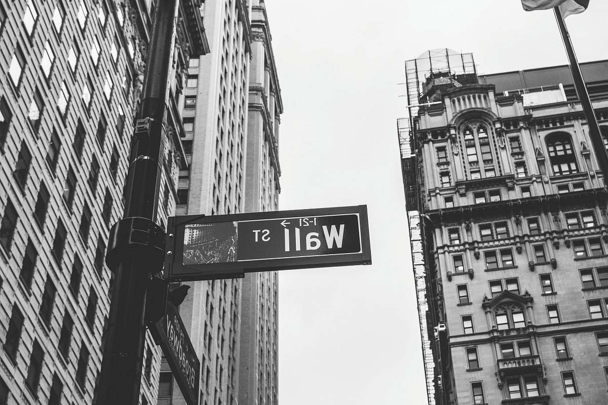 city grayscale photo of 1-21 Wall street signage wall street