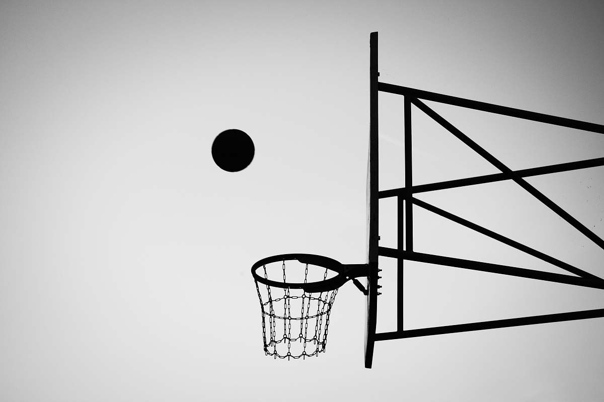 grey grayscale photo of ball about to shoot black