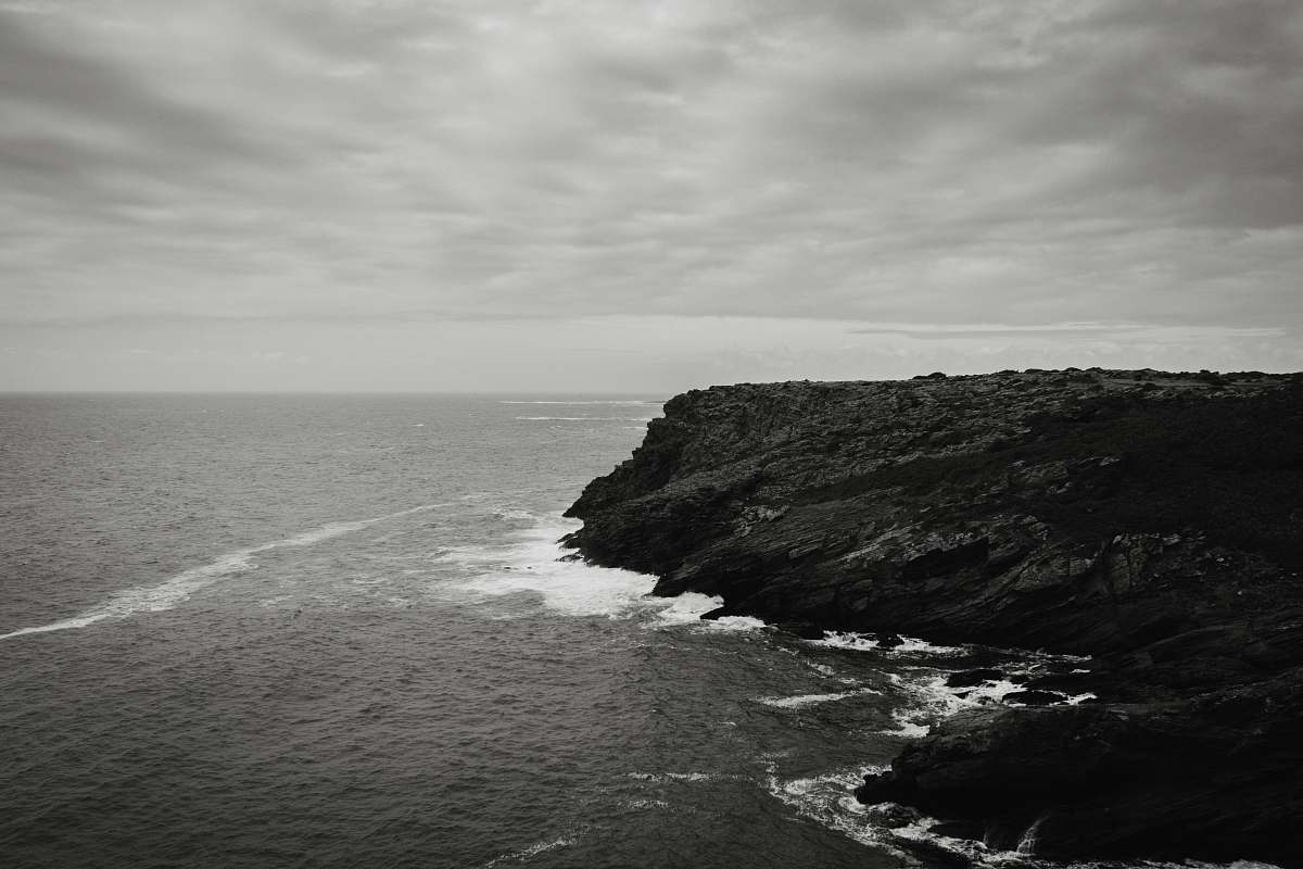 sea grayscale photo of body of water land