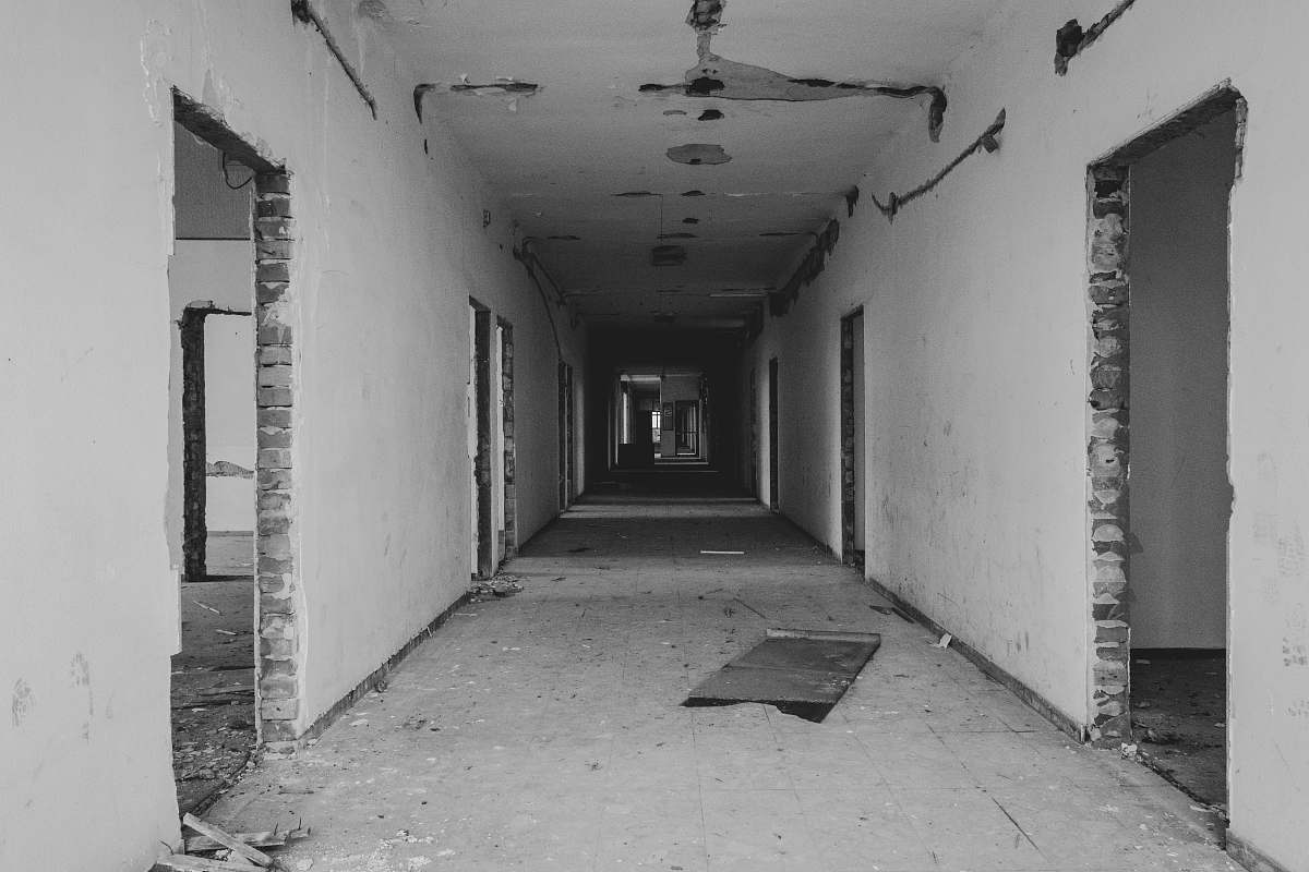 corridor grayscale photo of building interior floor