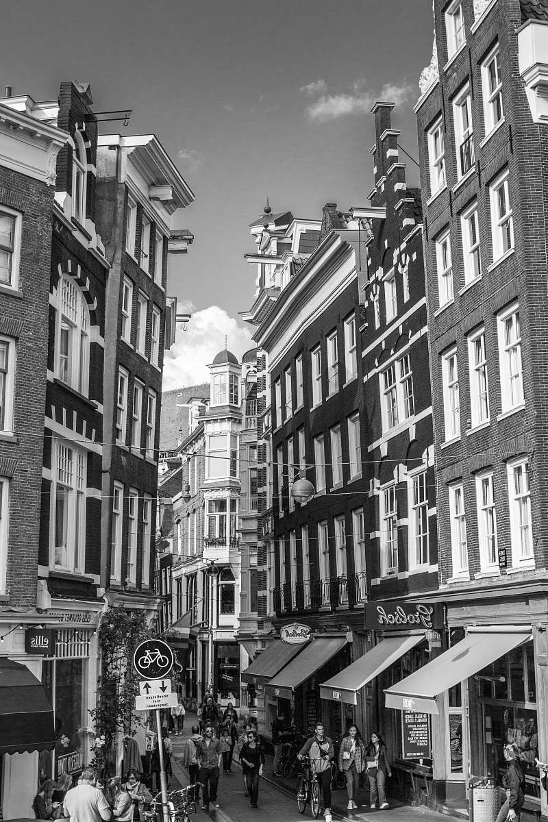 human grayscale photo of buildings person