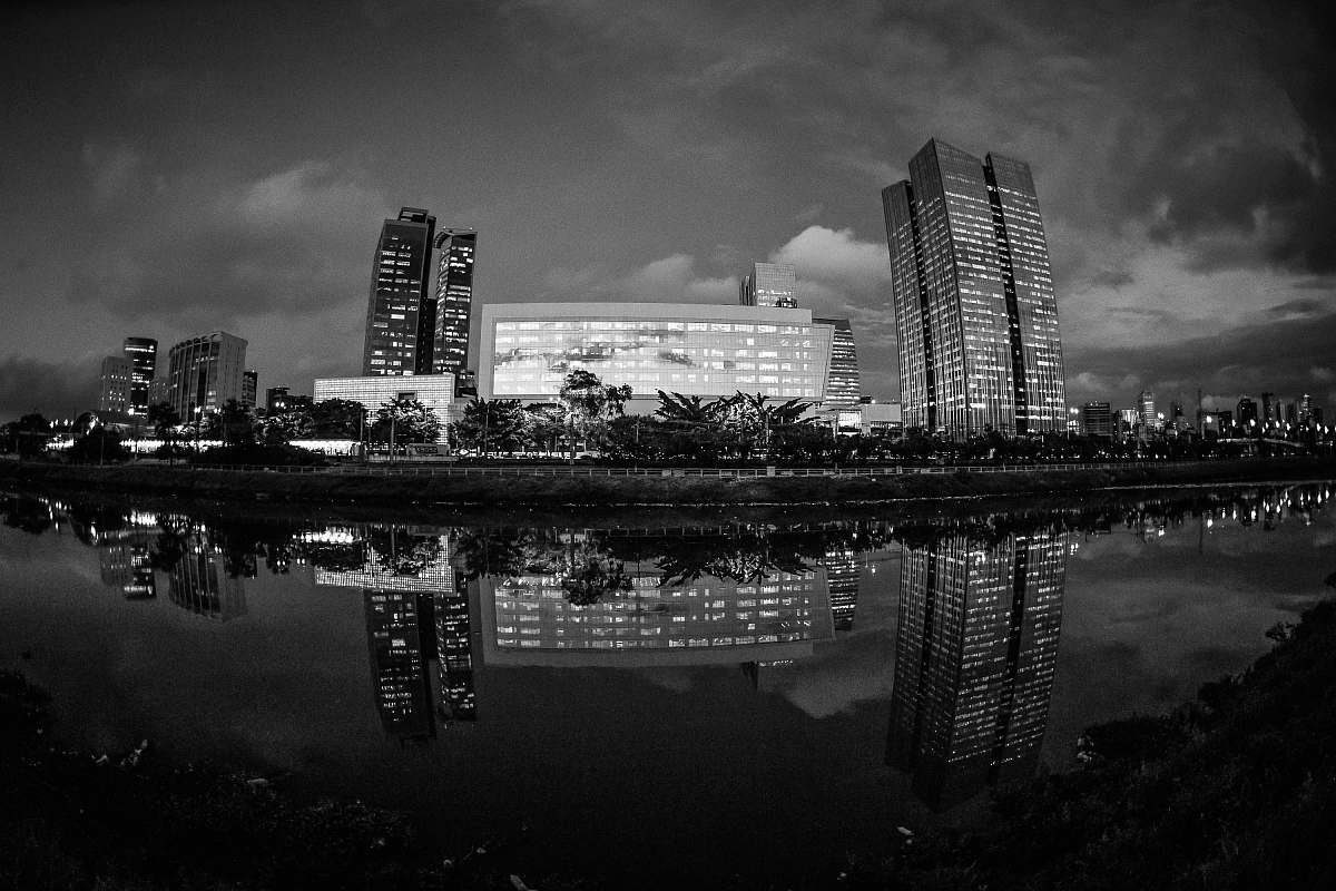 grey grayscale photo of buildings near body of water architecture