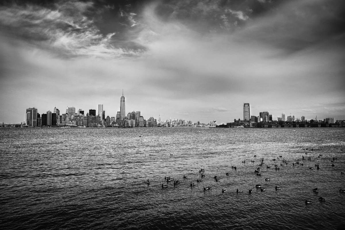 grey grayscale photo of city skyline ocean