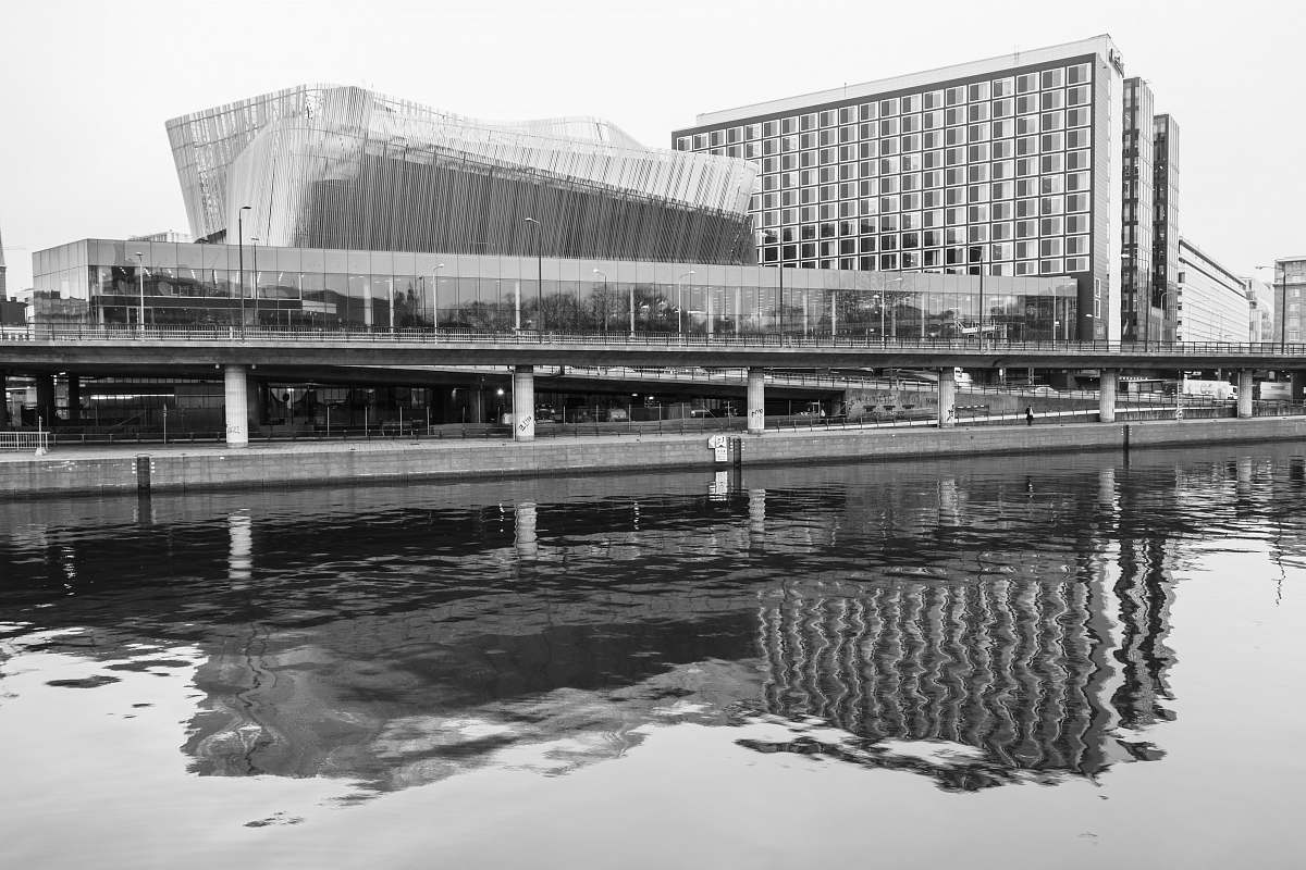 water grayscale photo of concrete bridge waterfront