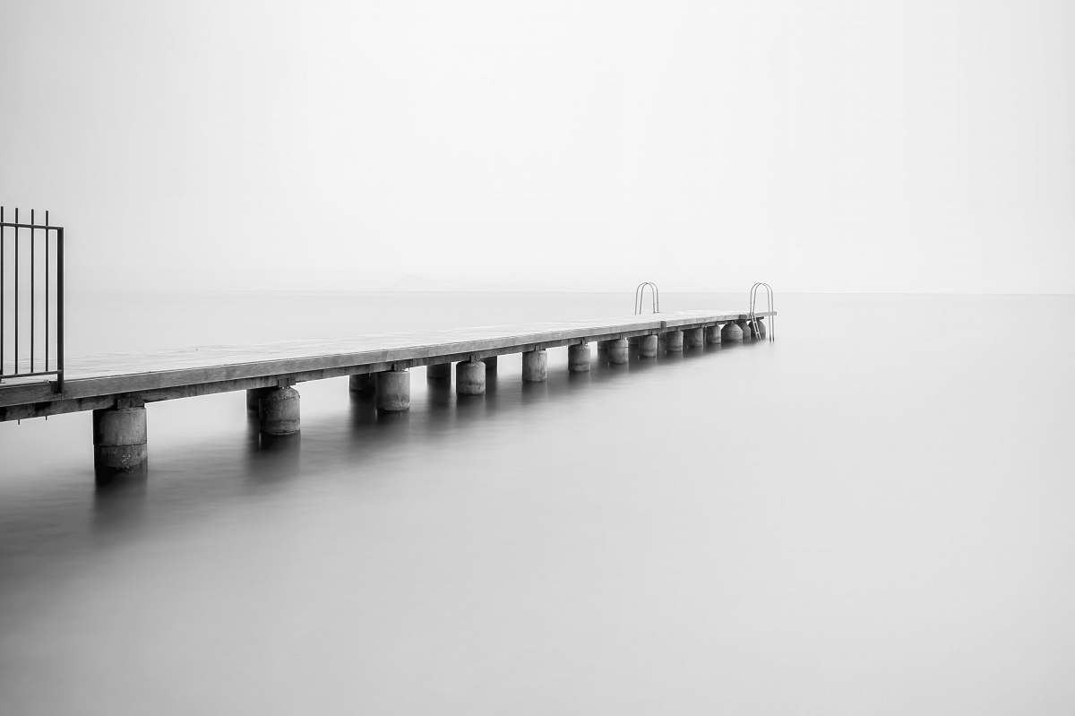 pier grayscale photo of concrete dock dock
