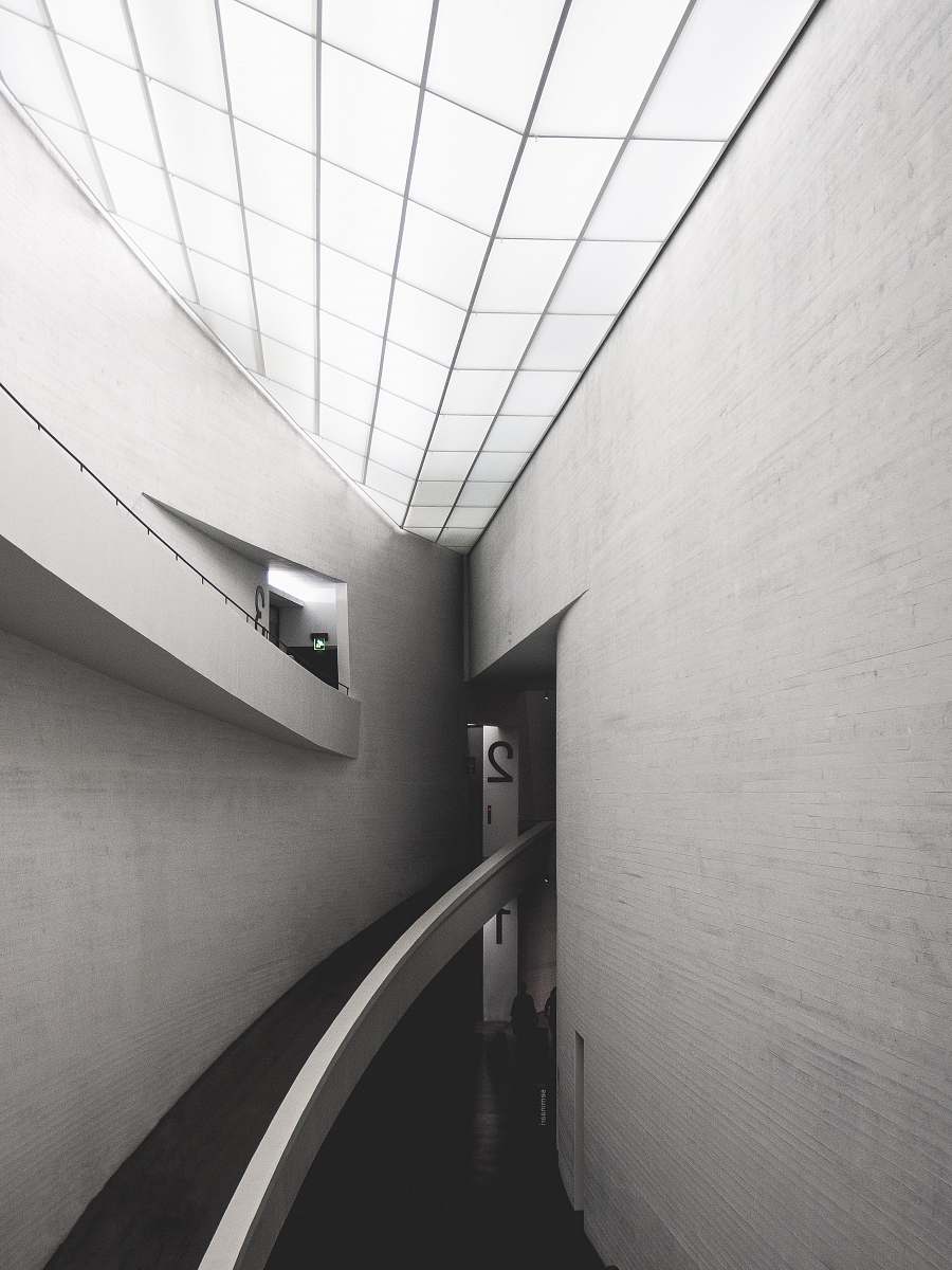 handrail grayscale photo of empty hallway banister
