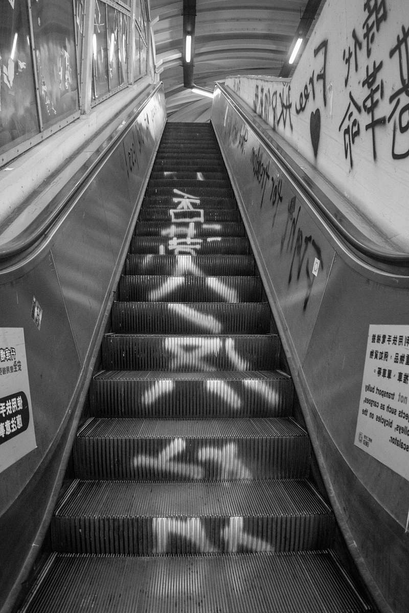 banister grayscale photo of escalator handrail