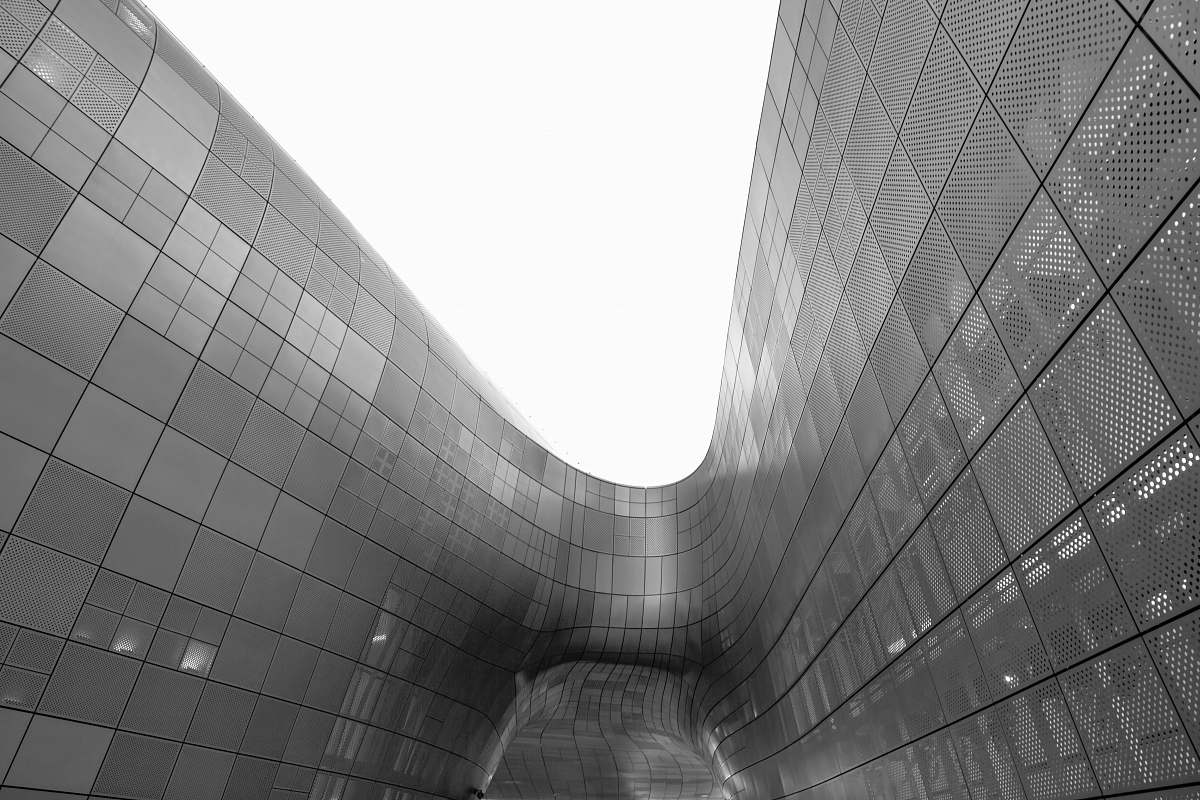 building grayscale photo of glass walled building architecture