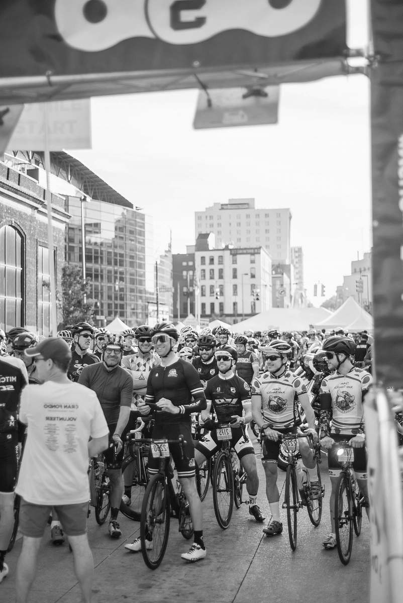 human grayscale photo of group of cyclist person