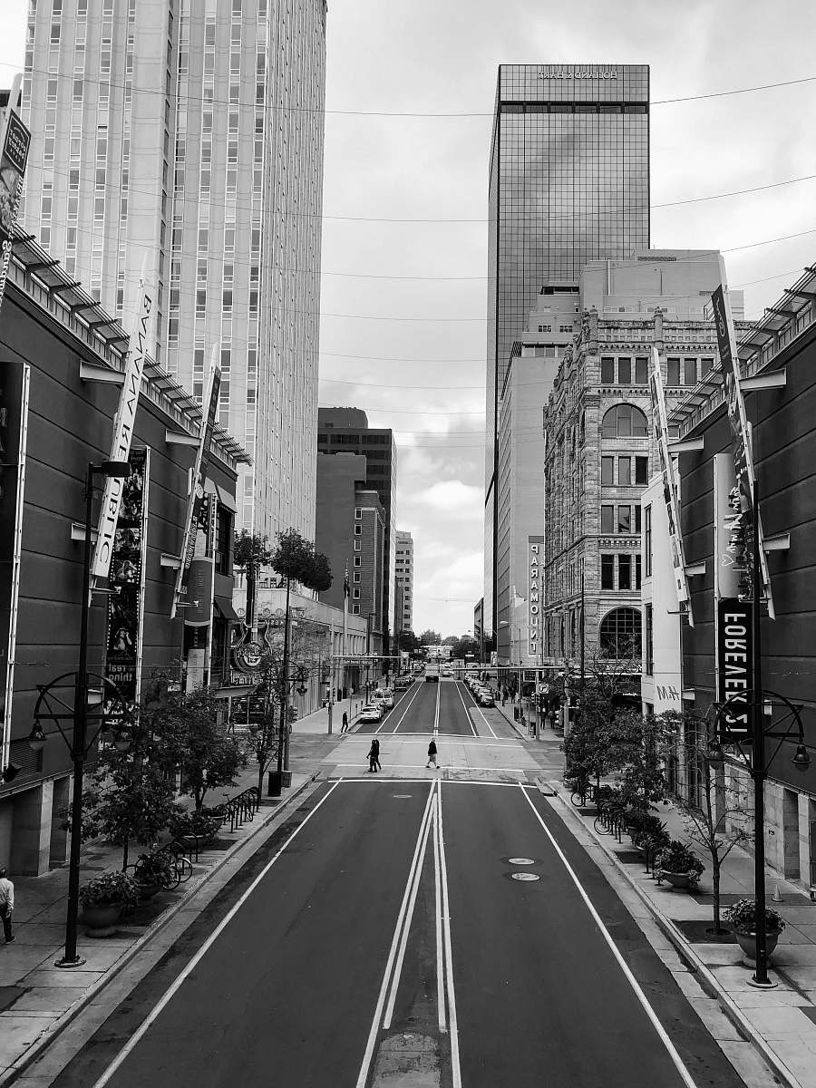 grey grayscale photo of high-rise buildings near road building