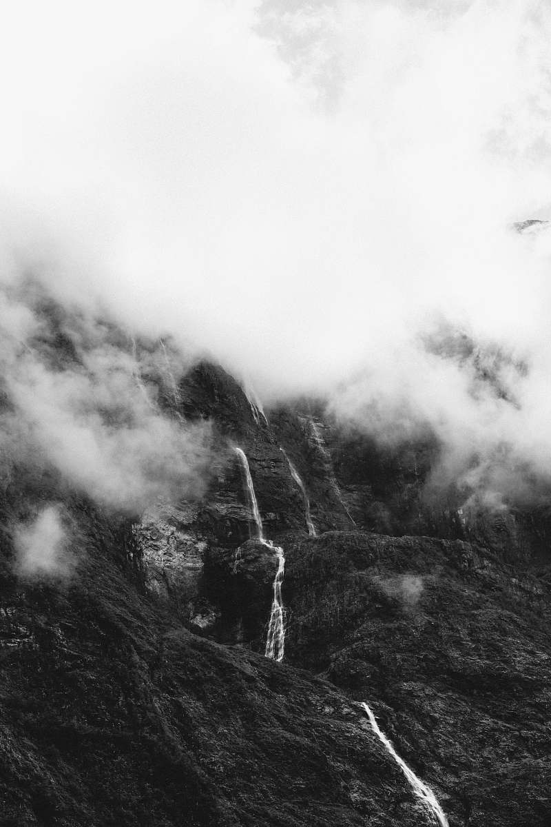 nature grayscale photo of hill covered with mist weather