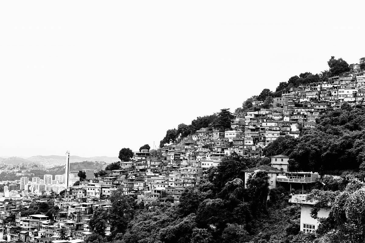 building grayscale photo of houses on hill urban