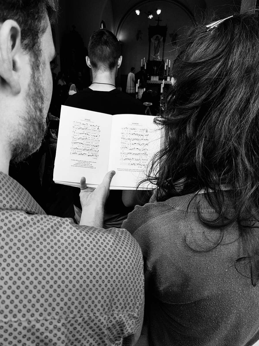 person grayscale photo of man holding book human