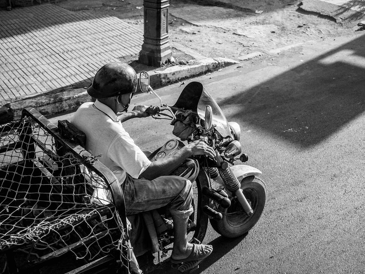 human grayscale photo of man wearing white top riding motorcycle person