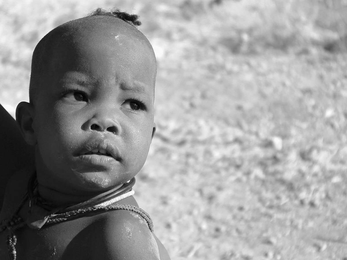 people grayscale photo of person carrying child human