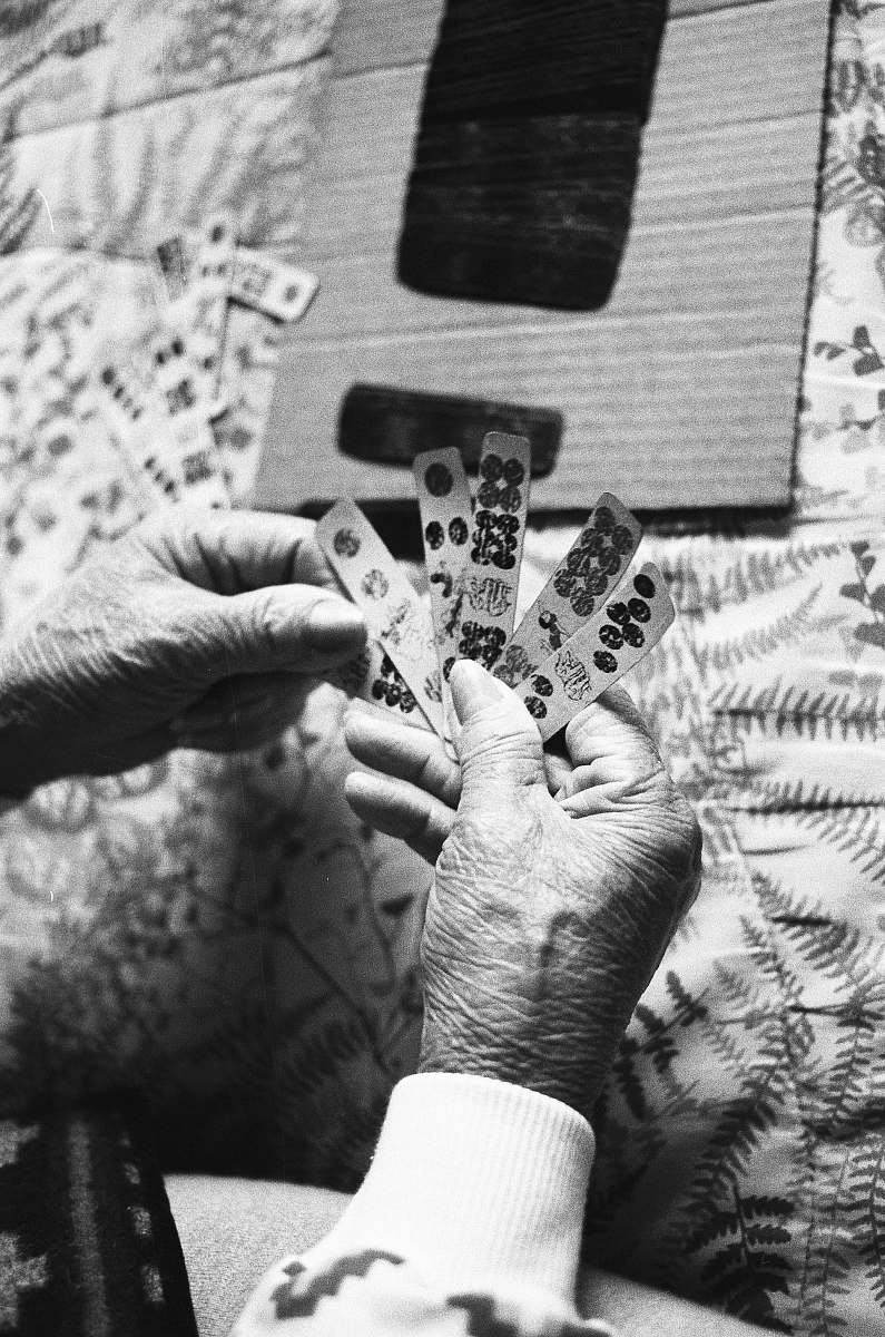 grey grayscale photo of person holding game chips human