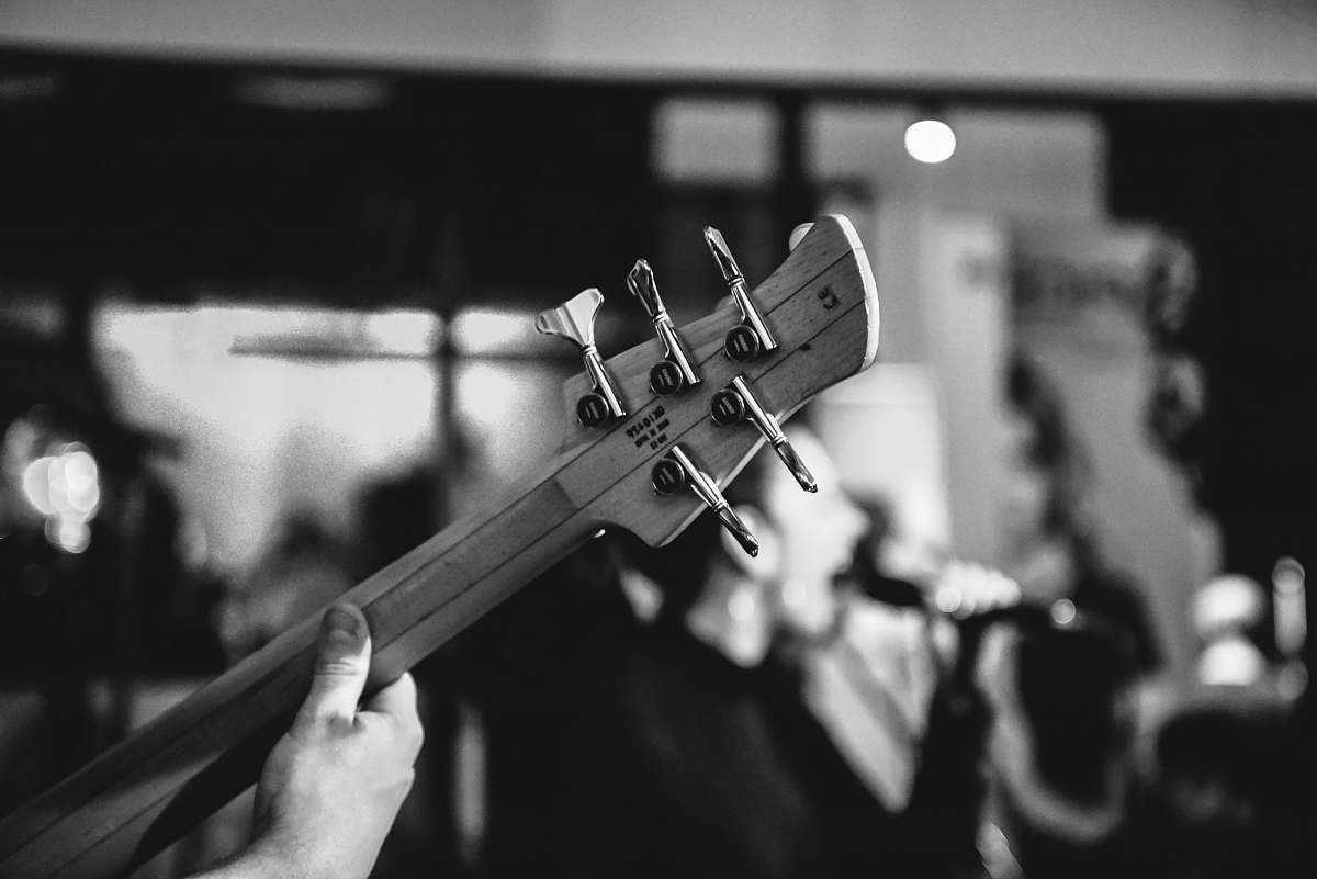 grey grayscale photo of person playing guitar guitar