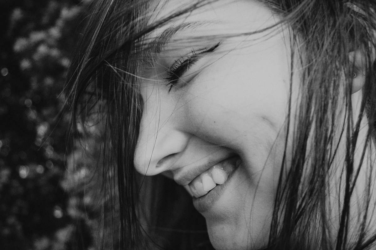 grey grayscale photo of smiling woman human