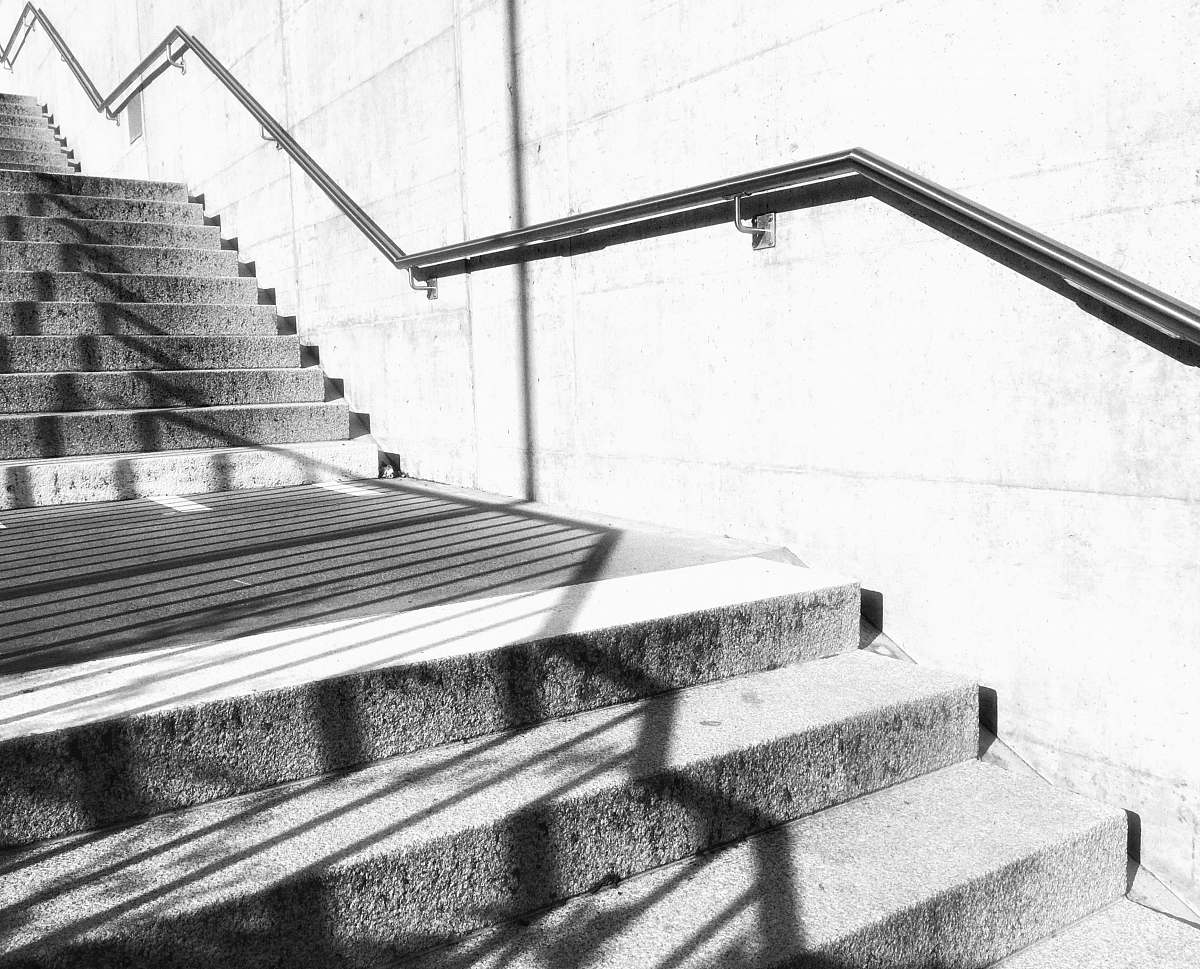 banister grayscale photo of stairs handrail