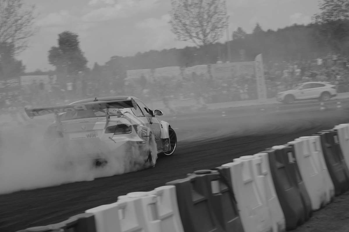 grey grayscale photo of vehicle drifting vehicle