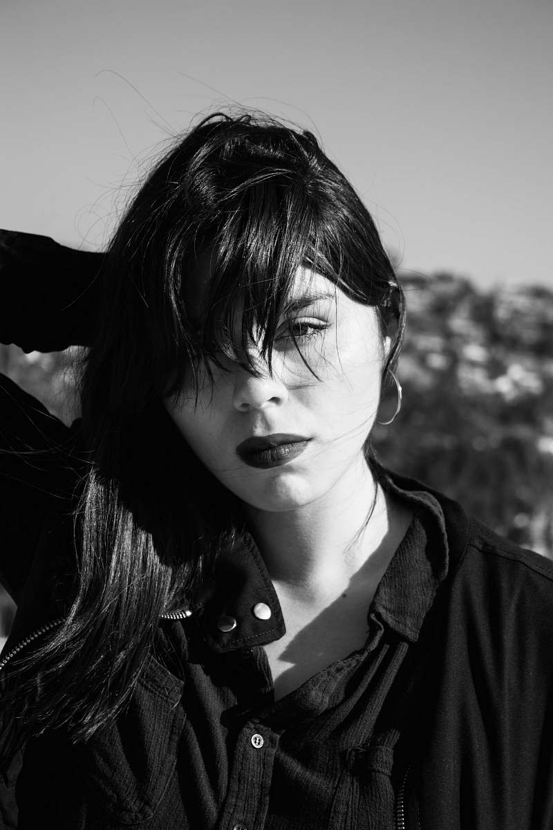 person grayscale photo of woman in button-up shirt face