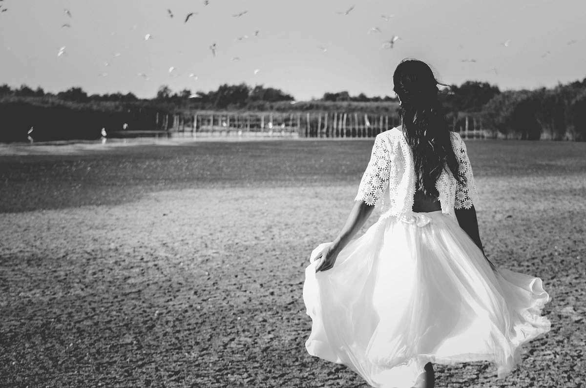 human grayscale photo of woman on grass field person